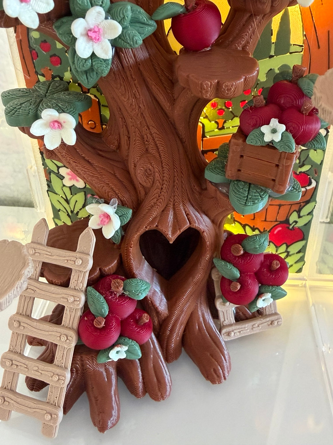 Cobbler's Orchard lower tree trunk heart hide, apple clusters, crate, and ladder detail