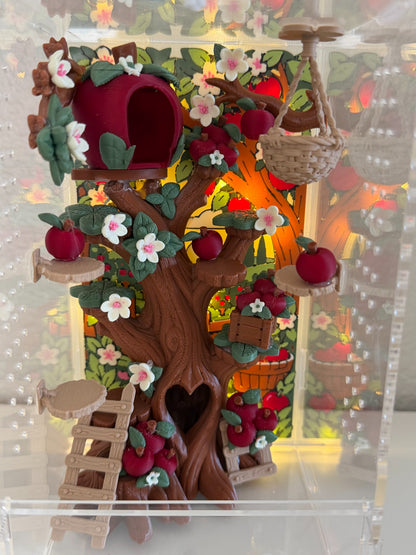 Cobbler's Orchard jumping spider enclosure with apple tree hide, climbing platforms, blossoms, apples, ladders, hanging basket, and warm backlighting